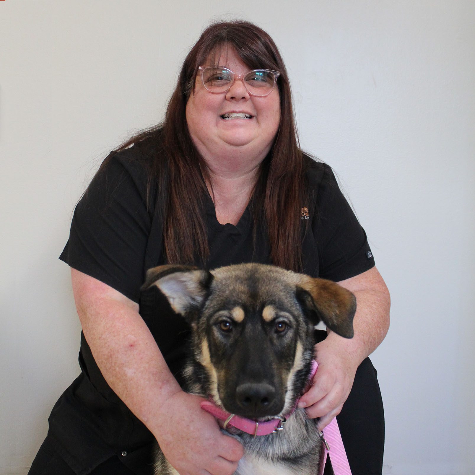 practice manager posing with puppy